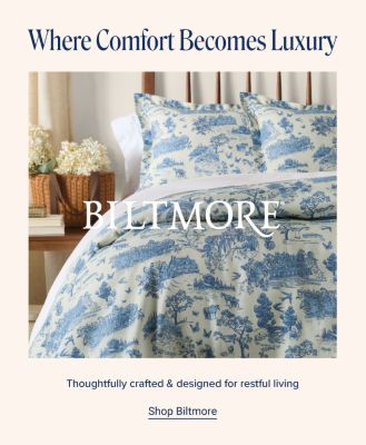 Biltmore. Where comfort becomes a luxury. A made bed with a with matching blue print designed bedspread. Thoughtfully crafted and designed for restful living. Shop Biltmore.