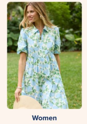 Shop women. A woman in a blue green floral print dress.