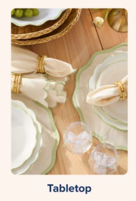 Shop tabletop. A table with plates, glassware and napkins.