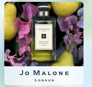 Shop Jo Malone London. A perfume bottle surrounded by pears and flowers.