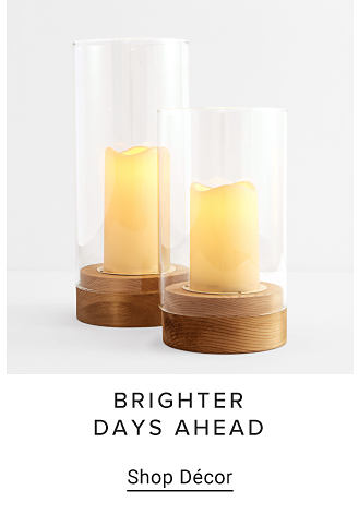 An image of candles encased in glass. Brighter days ahead. Shop decor. 