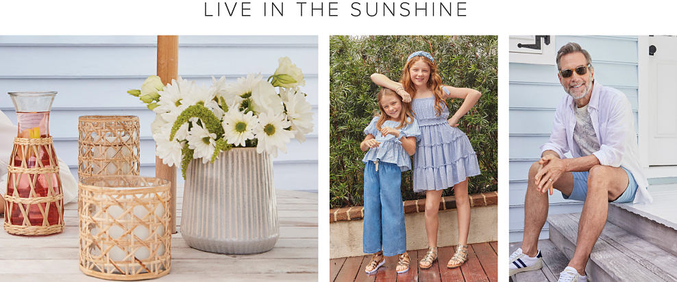 Live in the sunshine. An image of drinkware and a vase with flowers on a table. An image of two little girls wearing light blue outfits and sandals. An image of a man sitting on his deck wearing a white shirt, blue shorts, white sneakers and sunglasses.