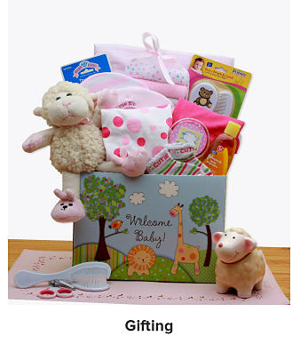 A basket that says welcome baby filled with a variety of baby gifts. Shop gifting.