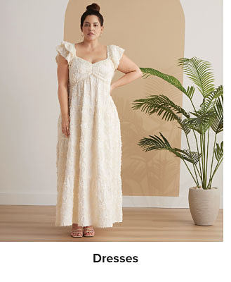 An image of a woman wearing a maxi dress. Shop dresses.