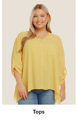 An image of a woman wearing a yellow top. Shop tops.