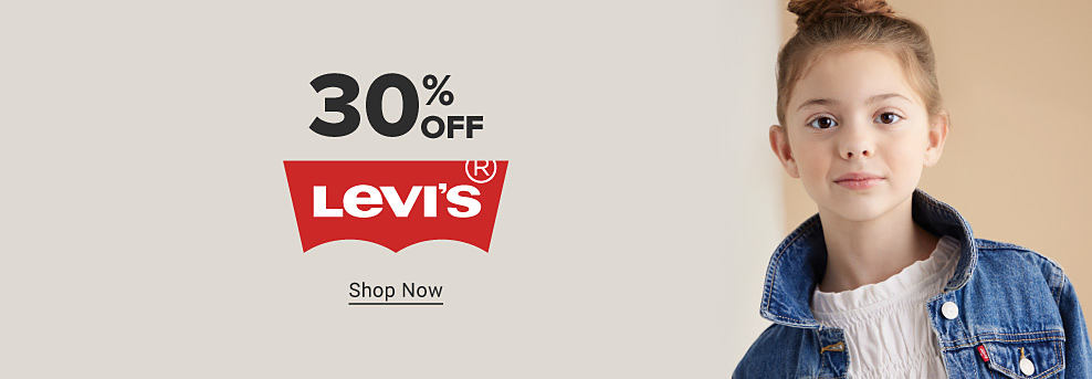 A girl in a denim Levi's jacket. 30% off Levi's. Shop now.