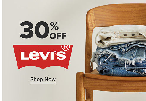 Levi's jeans stacked in a chair. 30% off Levi's. Shop now.