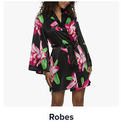 An image of a woman wearing a floral robe. Shop robes.