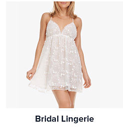 An image of a woman wearing white lingerie. Shop bridal lingerie.