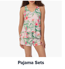 An image of a woman wearing floral pajamas. Shop pajama sets.