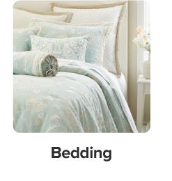 An image of a bed with a comforter and pillows to match. Bedding. 