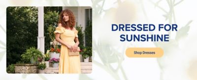 An image of a woman wearing a yellow dress. Dressed for sunshine. Shop dresses. 