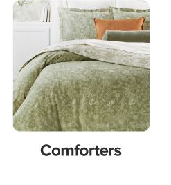 An image of a bed with a comforter and pillows to match. Comforters.