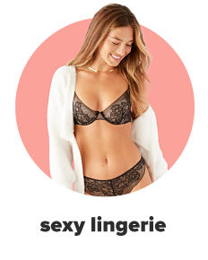 A woman in a purple and white bra and panty set and an open front cardigan. Shop sexy lingerie.