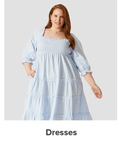 A woman in a blue tiered dress. Dresses. 