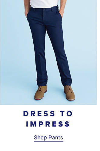 Dress To Impress. Image of man wearing blue pants with his hands in his pockets. Shop pants.