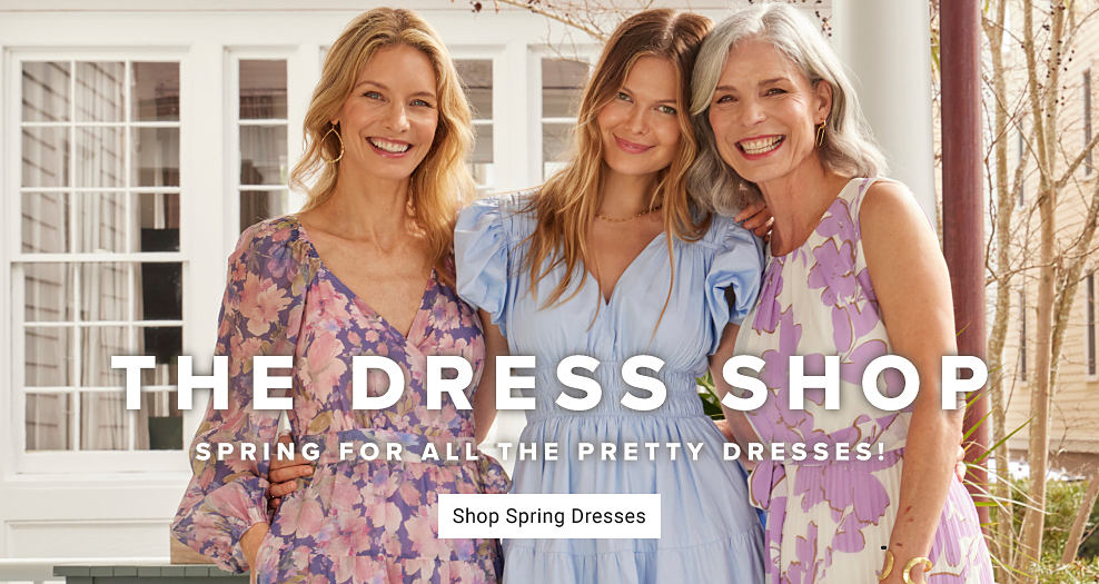 An image of a woman wearing a floral dress standing next to a women wearing a chambray dress and another women wearing a sleeveless floral dress. The dress shop. Spring for all the pretty dresses. Shop spring dresses.