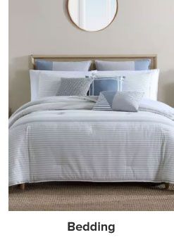 A bed covered in a Nautica bedding set. Shop bedding