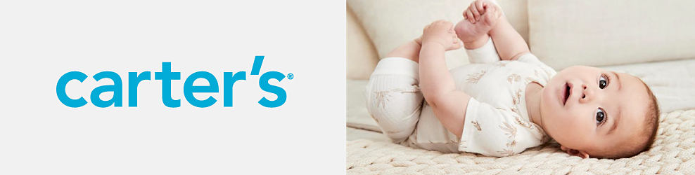 A baby wearing a Carter's onesie lays on a bed, grasping its toes. Carter's.