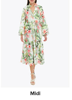An image of a woman wearing a floral dress. Shop midi