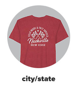 A red tee with a graphic of two flags and Nashville. City state. 