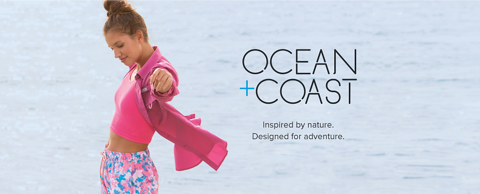 Woman wearing pink top and pink jacket. Ocean and Coast. Inspired by nature. Designed for adventure. 