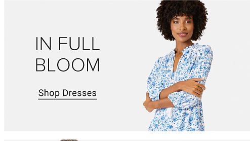 In Full Bloom. Image of a woman wearing a floral dress. Shop Dresses.