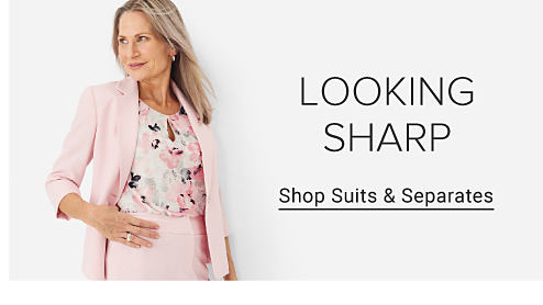 Image of a woman wearing a floral top and pink suit. Looking Sharp. Shop Suits & Separates.