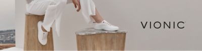 Image of a person wearing white sneakers. Vionic. 