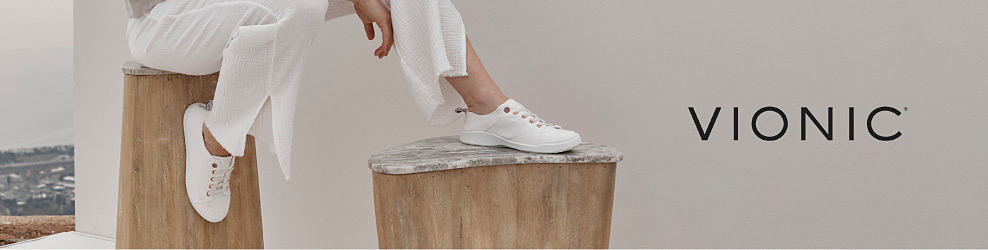 Image of a person wearing white sneakers. Vionic. 