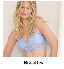 Image of a woman wearing a lavender lacy bra. Shop Bralettes.