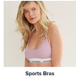Image of a woman wearing a light pink sports bra. Shop sports bras.