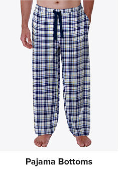 A man in blue plaid pajama bottoms. Shop pajama bottoms