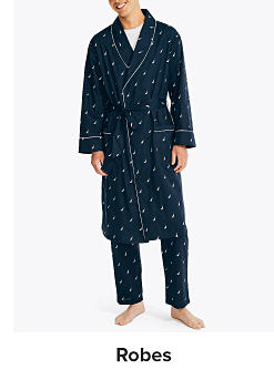 A man in a blue robe and blue pajama pants. Shop robes