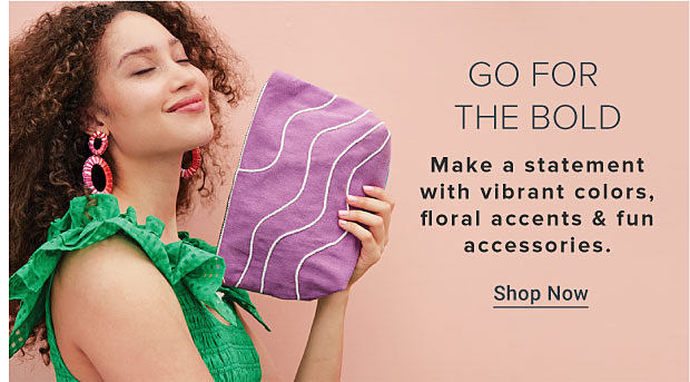 An image of a woman wearing a green dress, pink earrings and holding a purple handbag. Go for the bold. Make a statement with vibrant colors, floral accents and fun accessories. Shop now.