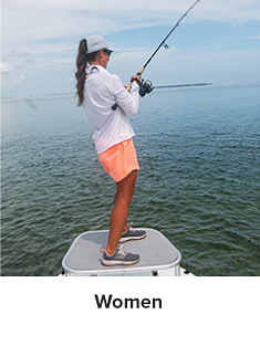 Woman wearing a cowl neck long sleeve and pink shorts and holding a fishing line. Women. 