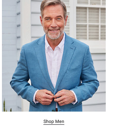 A man in a blue blazer and button up shirt. Shop men.