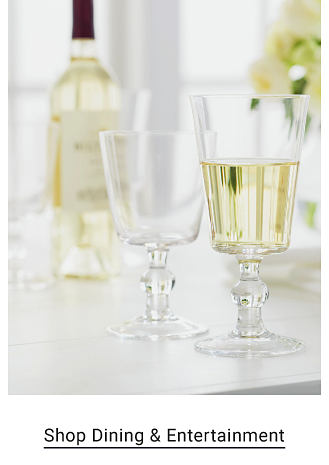 An image of a wine bottle and glasses. Shop dining and entertainment. 