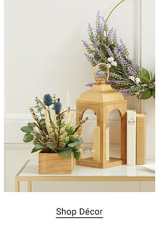 An image of a candle holder and artificial flowers. Shop decor. 