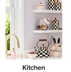 A checkered teapot and matching canisters. Shop kitchen.