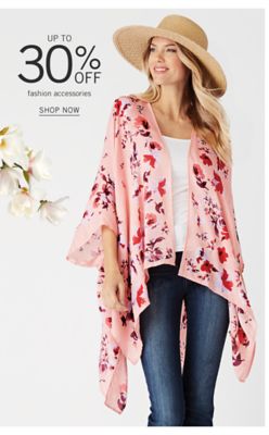 A woman wearing a fancy straw sun hat, a multi colored floral print wrap, a white top & blue jeans. Up to 30% off fashion accessories. Shop now.