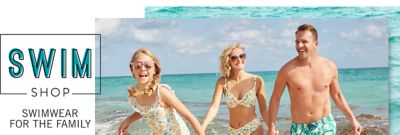 A girl wearing sunglasses & a white, yellow & green lemon print one piece swimsuit standing next to a woman wearing a sunglasses & a white, yellow & green lemon print bikini & a man wearing a teal, yellow & white print swim trunks. Swim Shop. Swimwear for the Family.