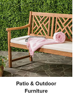 An image of a wooden bench outside with a pink blanket on it. Shop patio and outdoor furniture.