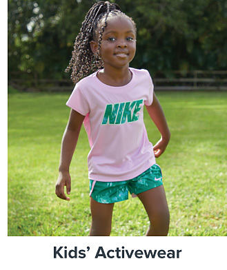 An image of a girl wearing activewear. Shop kids' activewear.