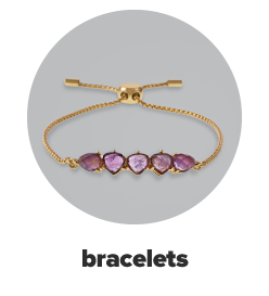 A gold bracelet with five purple gemstones. Bracelets.