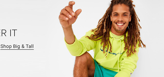 A man in a bright yellow long sleeve Champion shirt and teal shorts. Get after it. Shop big and tall. 