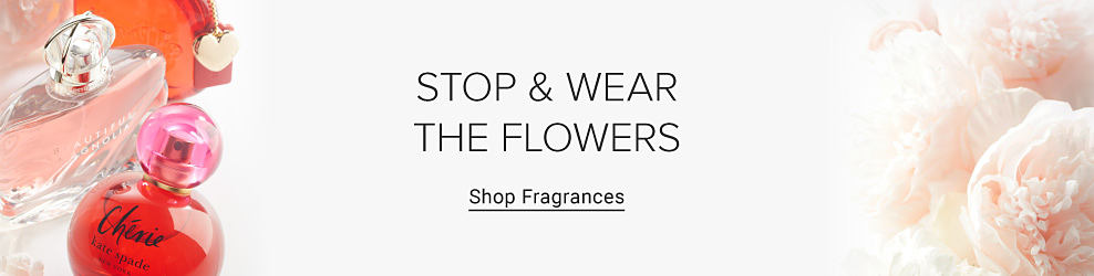 An image of fragrance bottles and flowers. Stop and wear the flowers. Shop fragrances.