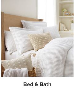 A bedding set in white and beige. Shop bed and bath.