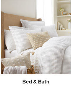 A bedding set in white and beige. Shop bed and bath.