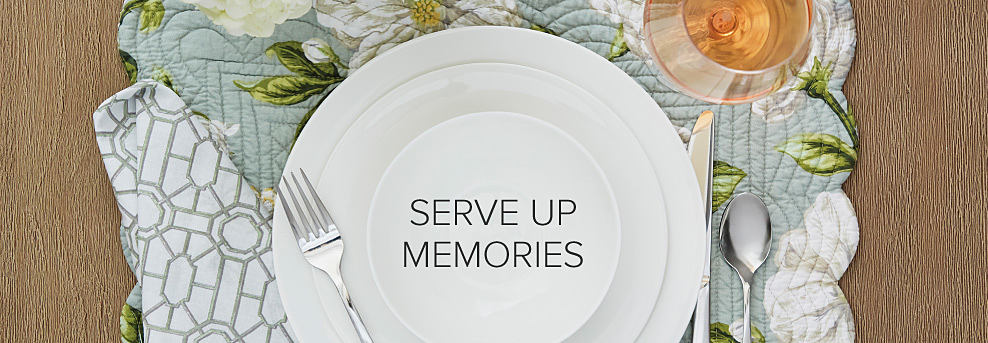 Image of a floral place setting with silverware and plates. Serve up memories.